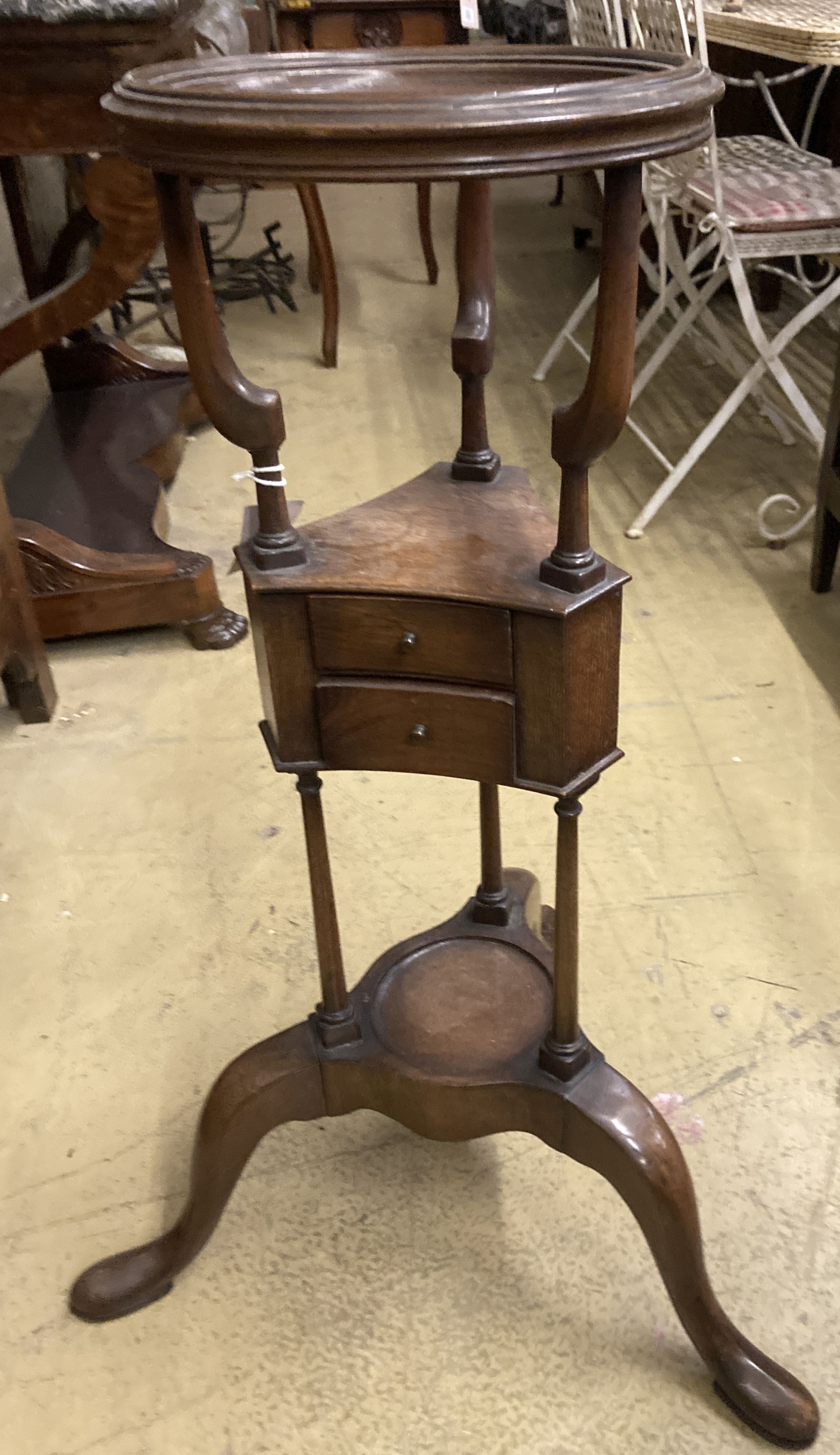 A George II style mahogany washstand, with open bowl stand over two triangular soap drawers and a jug platform, raised on cabriole legs